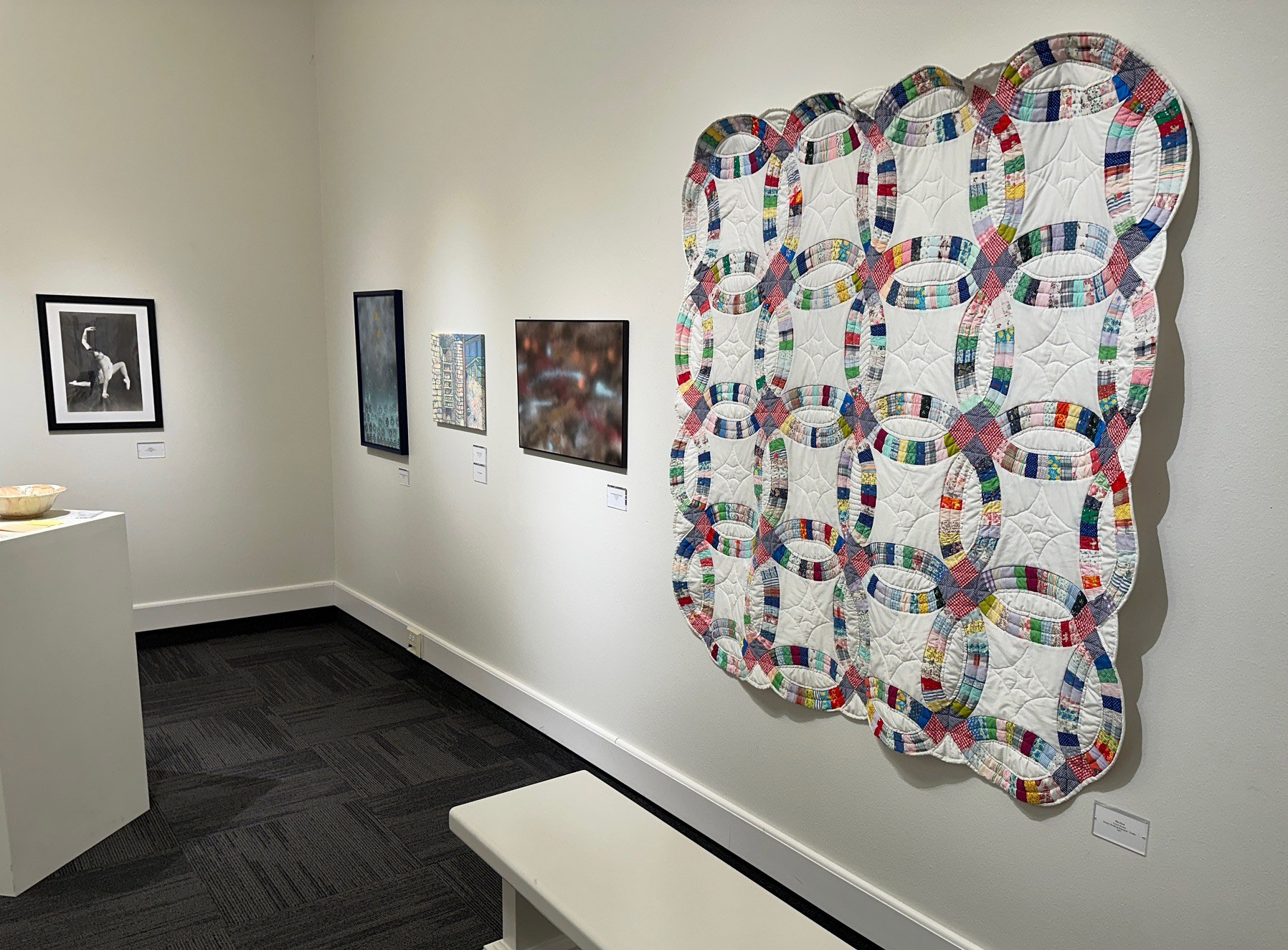 Image of a quilt hanging on a white wall